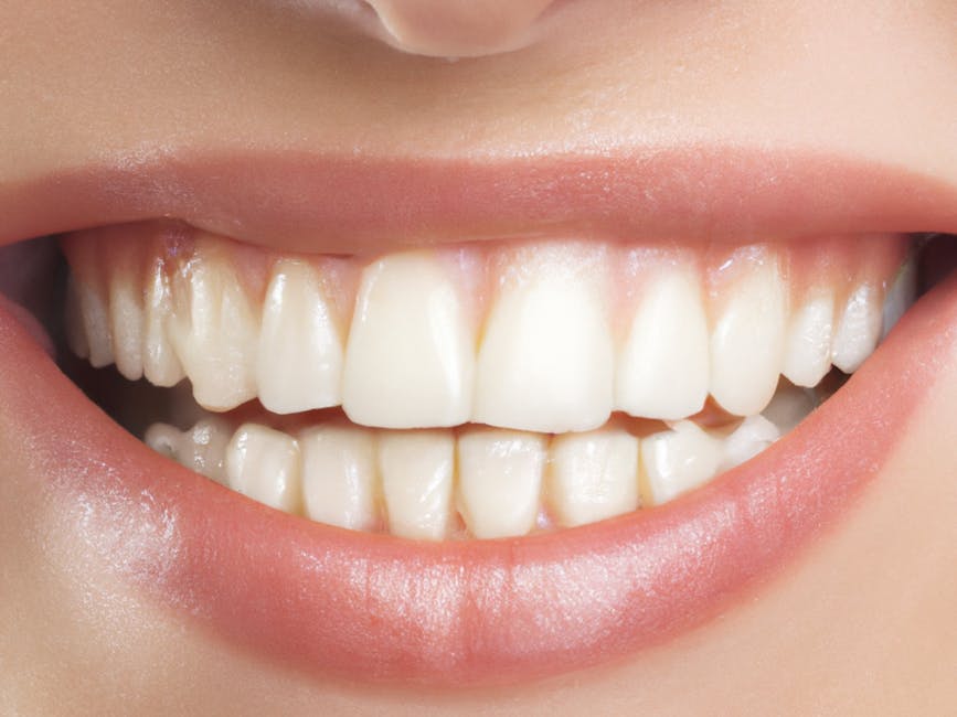 Close-up of a person's mouth showing a broad, happy smile with straight, white teeth and slightly parted lips. The background includes part of the face and skin texture, with natural lighting highlighting the dental and facial features. This image is often associated with health, oral hygiene, or positive emotions, and can be used in contexts related to home relocation or packing and moving services, such as those offered by Man with Van Welling, particularly in articles on disposal or moving logistics for bulky items or furniture during a house move.